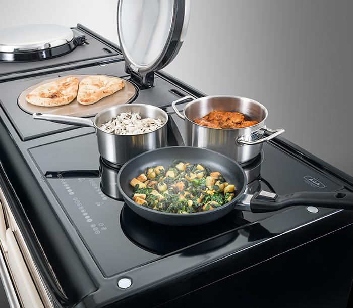 AGA induction hob with pans cooking on top 